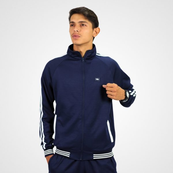 FW1 Model wearing a navy Frontier Falcon tracksuit with zip-up jacket and matching trousers, featuring contrast stripe details.