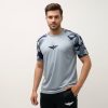 Model wearing Falcon’s Performance Tee in camouflage grey. Lightweight, breathable half-sleeve fit suitable for training, running, and athletic activities