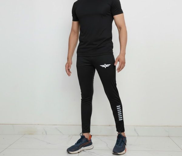 unnamed (19) Model wearing Falcon’s Apex Summer Trousers in black. Lightweight breathable fit with ergonomic design suitable for training, running, and athletic activities